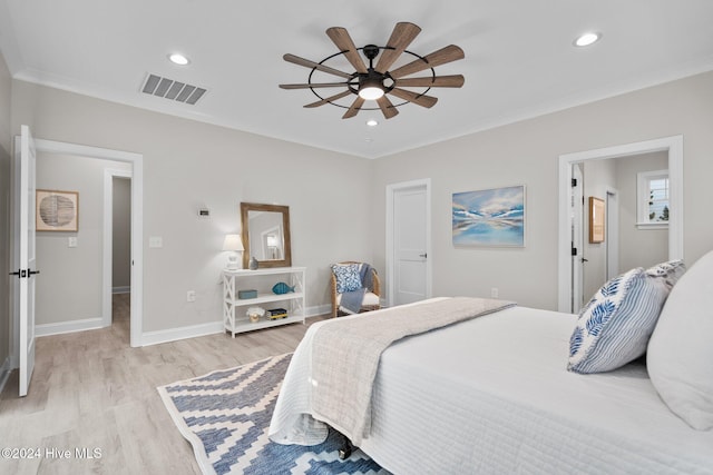 bedroom featuring ceiling fan, light wood-type flooring, and ornamental molding