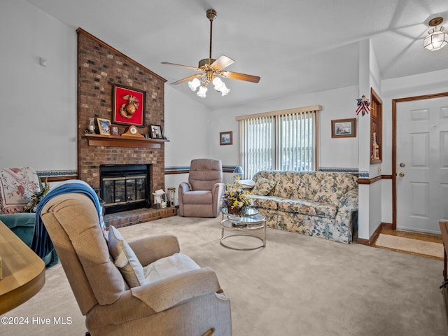 carpeted living room featuring ceiling fan, high vaulted ceiling, and a brick fireplace