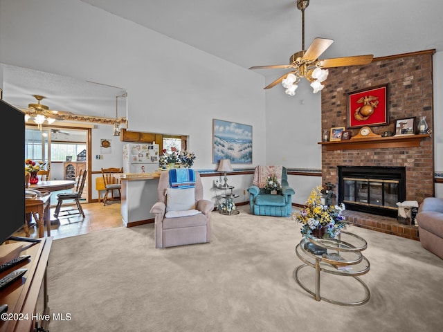 carpeted living room with ceiling fan, vaulted ceiling, and a brick fireplace