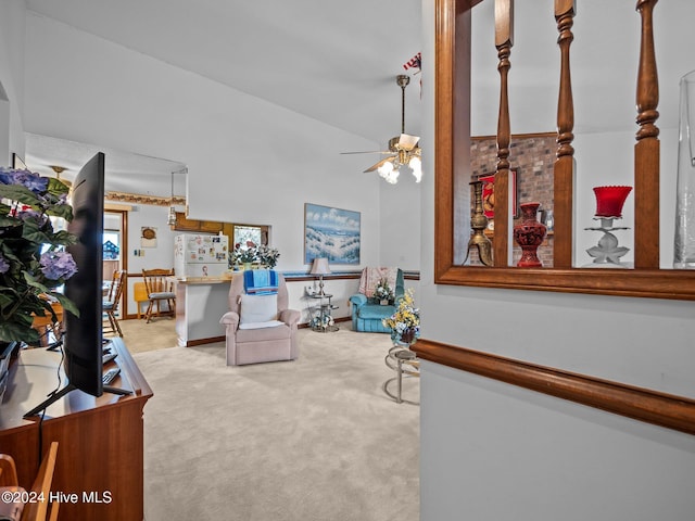 dining area with a textured ceiling, light colored carpet, and ceiling fan