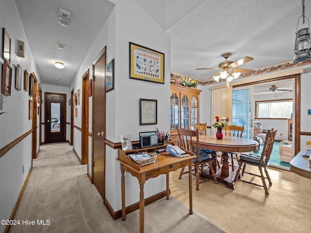 interior space with ceiling fan and a textured ceiling