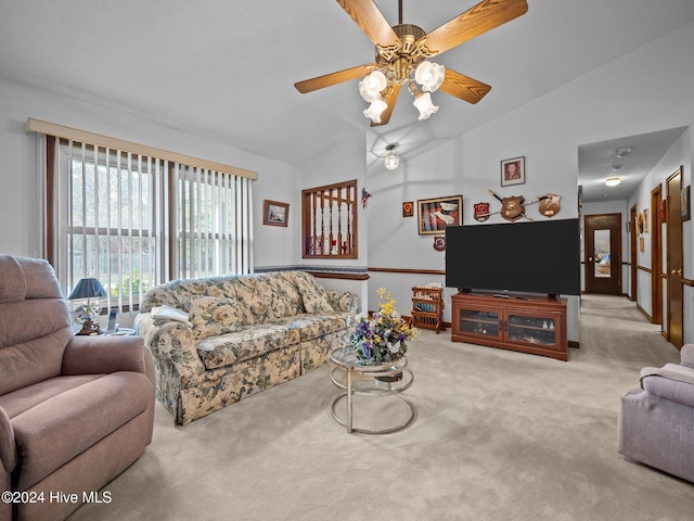 carpeted living room with ceiling fan and lofted ceiling