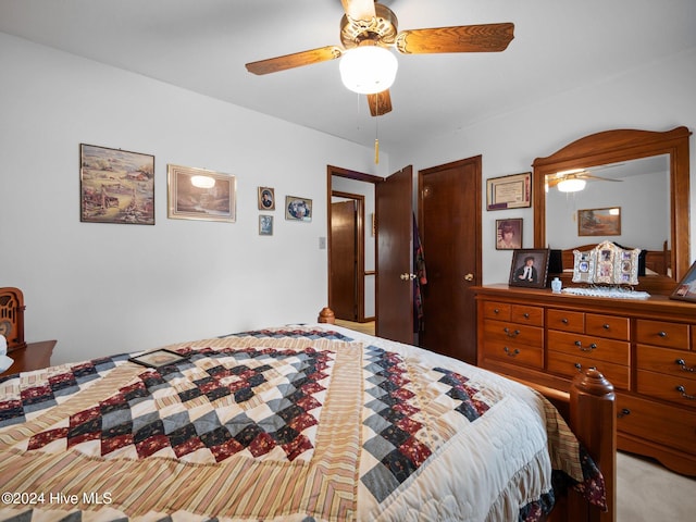 bedroom featuring light carpet, a textured ceiling, and ceiling fan