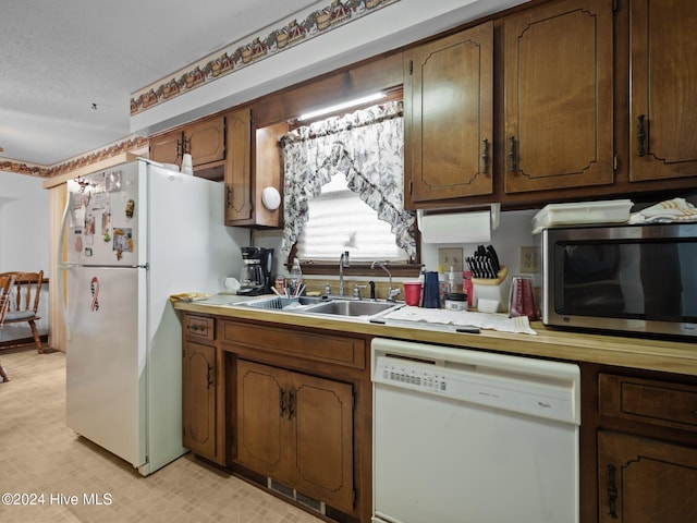 kitchen featuring white appliances and washer / dryer