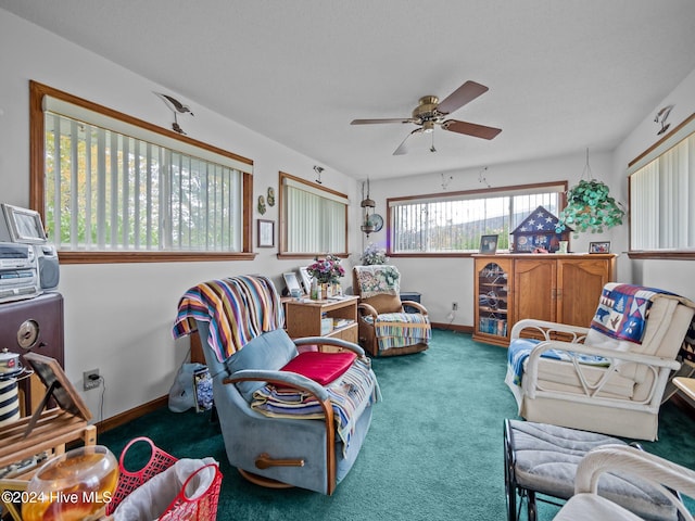 living room with ceiling fan and carpet