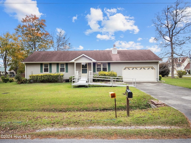 ranch-style house with covered porch, a front yard, and a garage