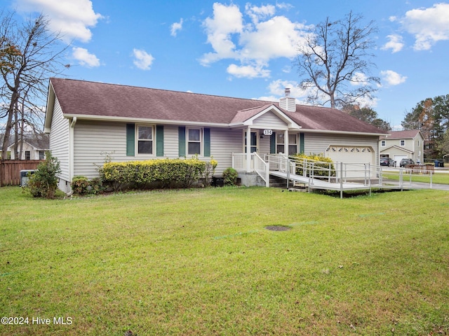 ranch-style home featuring a front lawn, covered porch, and a garage