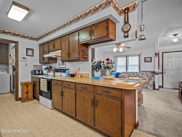 dining room featuring ceiling fan and washer / dryer