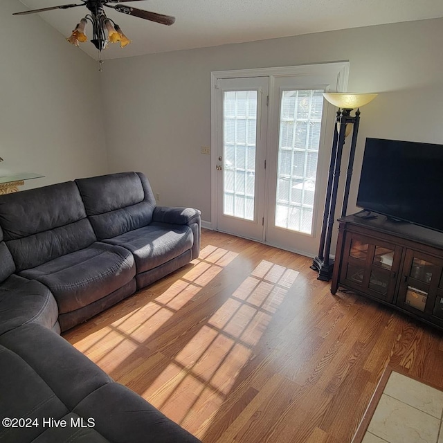 living room with ceiling fan and light wood-type flooring