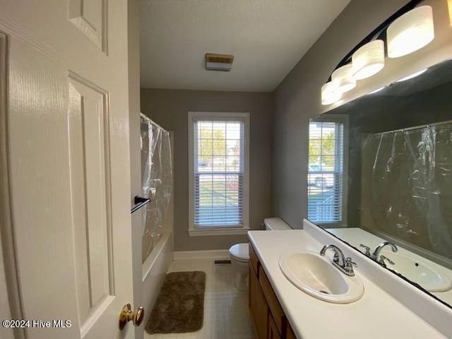 full bathroom featuring tile patterned flooring, vanity, toilet, and shower / bath combo