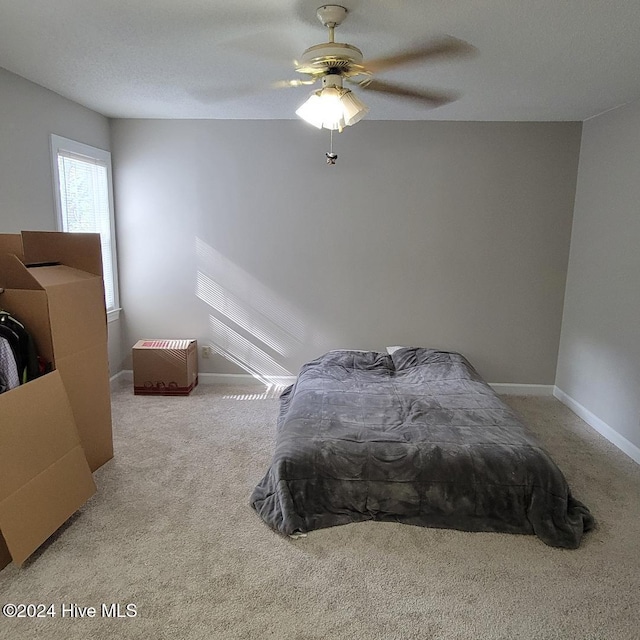 bedroom with light carpet and ceiling fan