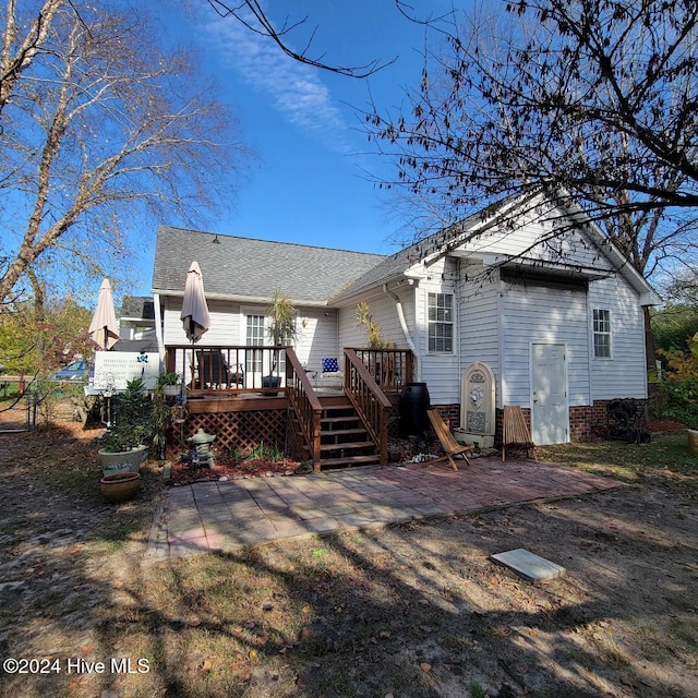 rear view of property with a wooden deck