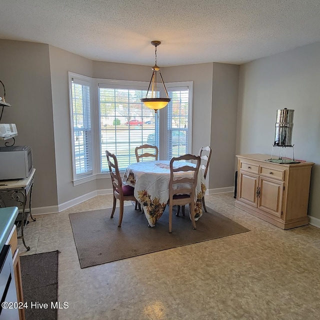 dining space with a textured ceiling