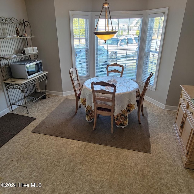 dining room featuring light carpet