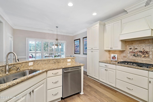 kitchen with premium range hood, sink, white cabinetry, light hardwood / wood-style flooring, and appliances with stainless steel finishes