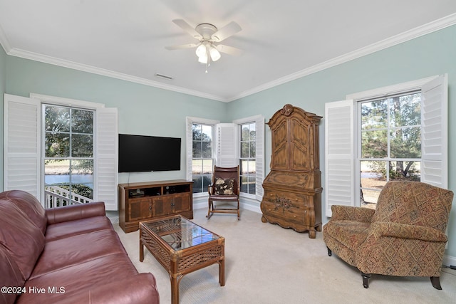 carpeted living room featuring ceiling fan, ornamental molding, and a wealth of natural light