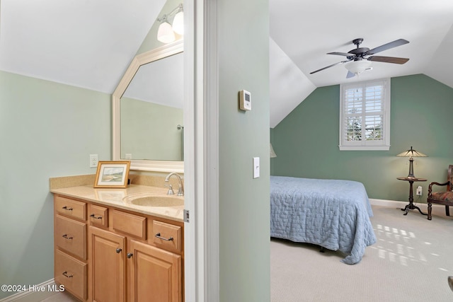 bedroom with ceiling fan, lofted ceiling, sink, and light carpet