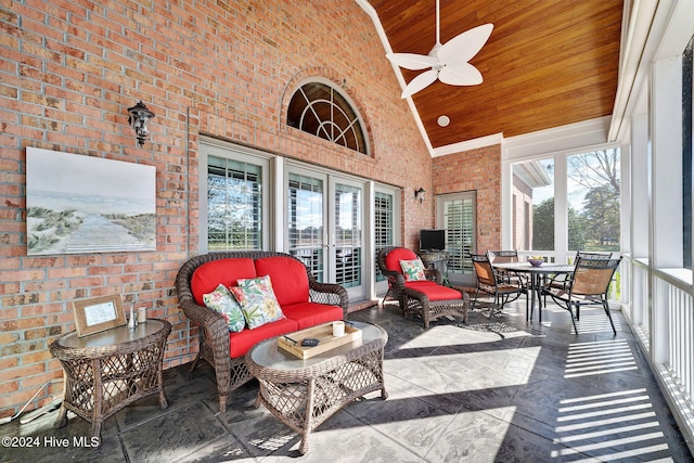 sunroom featuring lofted ceiling, wood ceiling, and ceiling fan