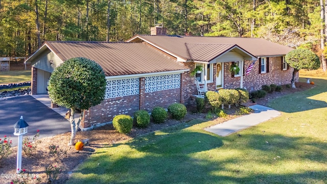 view of front of house with a front yard and a garage