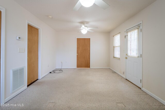 carpeted bedroom featuring a textured ceiling and ceiling fan