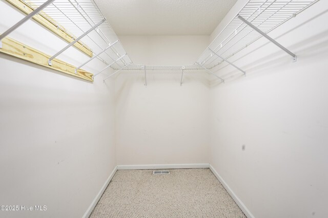 bathroom featuring toilet, a textured ceiling, a healthy amount of sunlight, and vanity