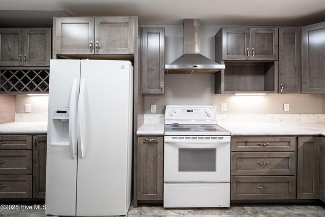 kitchen with white appliances and wall chimney exhaust hood