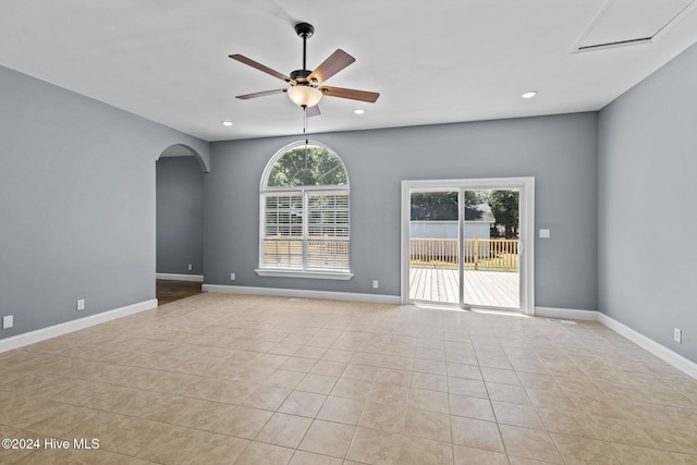 spare room featuring ceiling fan and light tile patterned flooring