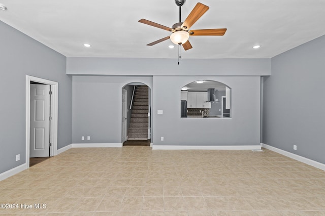 unfurnished living room featuring ceiling fan