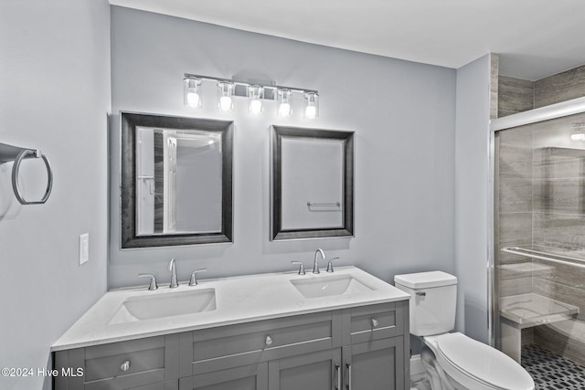 bathroom featuring vanity, toilet, and an enclosed shower