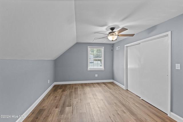 additional living space featuring ceiling fan, lofted ceiling, and light wood-type flooring