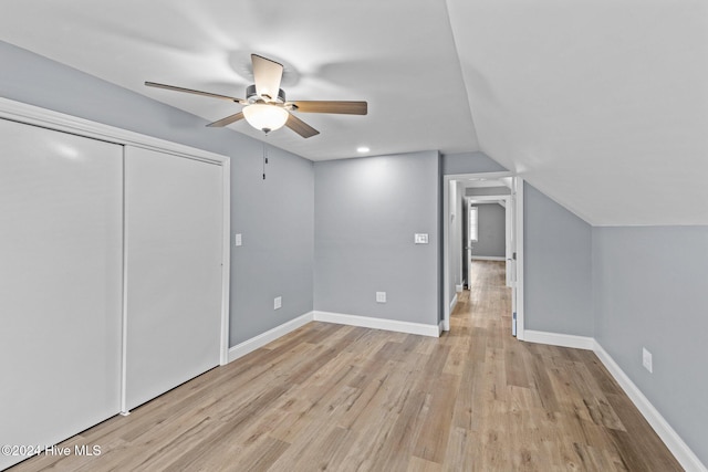 additional living space with light hardwood / wood-style floors, ceiling fan, and lofted ceiling