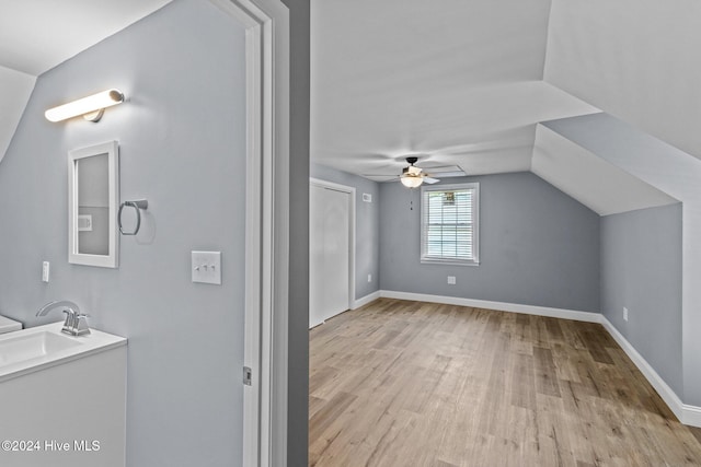 bathroom featuring hardwood / wood-style flooring, ceiling fan, lofted ceiling, and sink