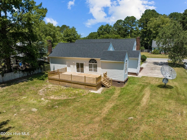 rear view of property featuring a yard and a deck