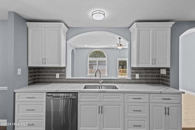 kitchen featuring dishwasher, sink, and white cabinets