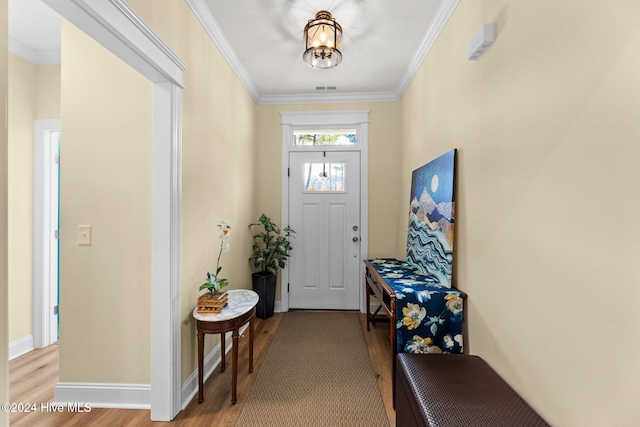 foyer entrance with crown molding and light wood-type flooring