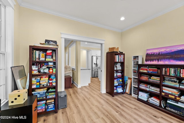 interior space with crown molding and light hardwood / wood-style floors