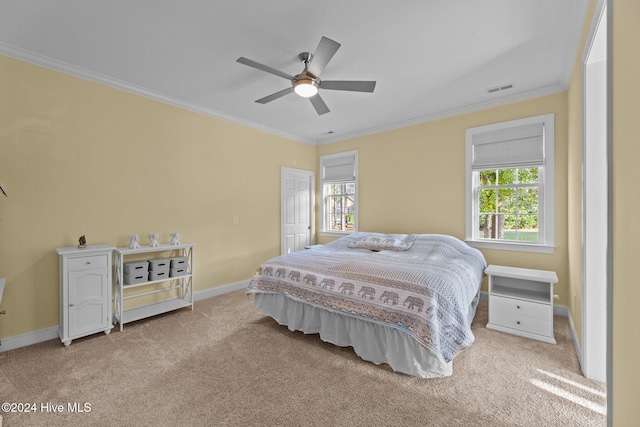 bedroom with ceiling fan, light carpet, and ornamental molding