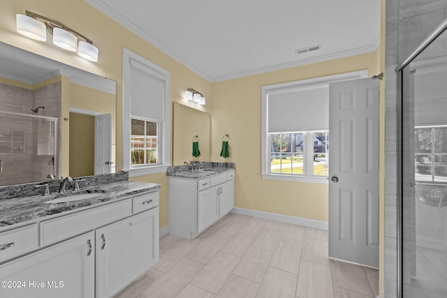 bathroom featuring vanity, crown molding, an enclosed shower, and a healthy amount of sunlight