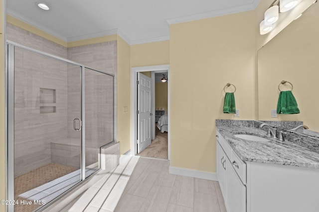 bathroom featuring tile patterned flooring, vanity, walk in shower, and ornamental molding