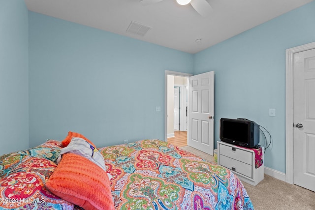 bedroom with light carpet and ceiling fan