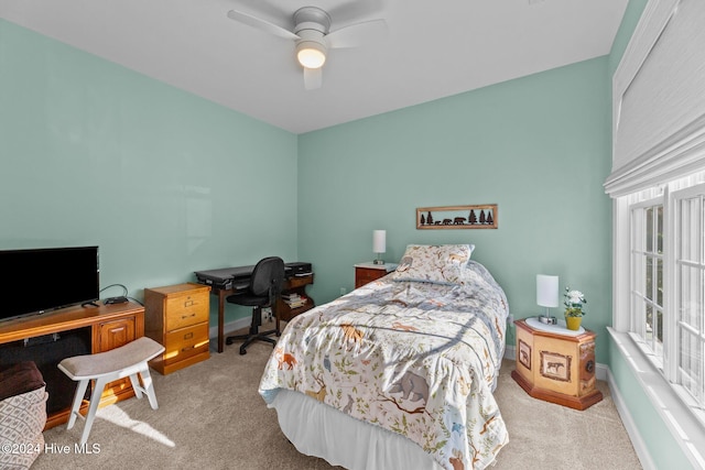 bedroom with ceiling fan and light carpet