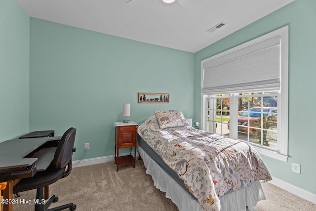 bedroom featuring light colored carpet and ceiling fan