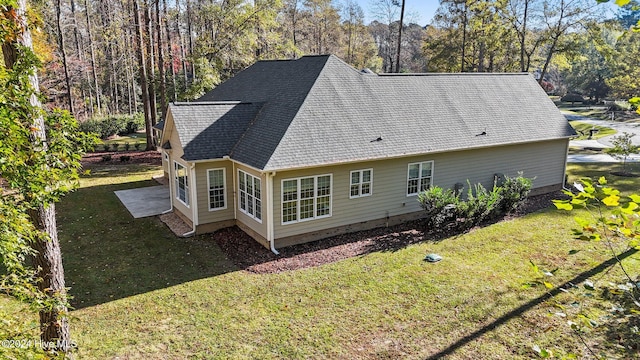 rear view of property with a lawn and a patio area