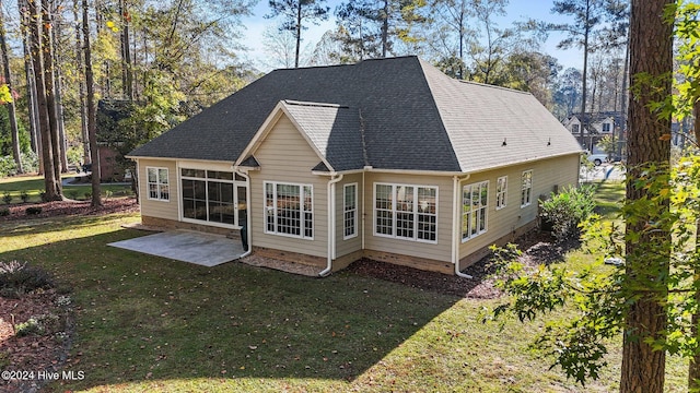 rear view of property featuring a patio area and a yard