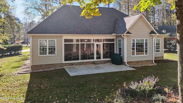 rear view of house featuring a patio area and a yard