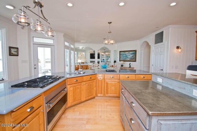 105 Wind Dance Ln, Swansboro, NC 28584 - kitchen with oven, stainless steel gas stovetop, arched walkways, light wood-style floors, and a sink