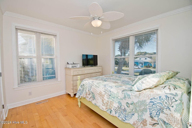 bedroom with ceiling fan, light hardwood / wood-style flooring, and crown molding