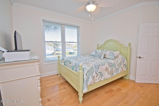 bedroom featuring ceiling fan, light hardwood / wood-style flooring, and ornamental molding