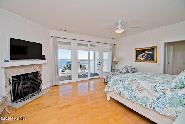 105 Wind Dance Ln, Swansboro, NC 28584 - bedroom with crown molding, access to outside, wood finished floors, a fireplace, and ceiling fan