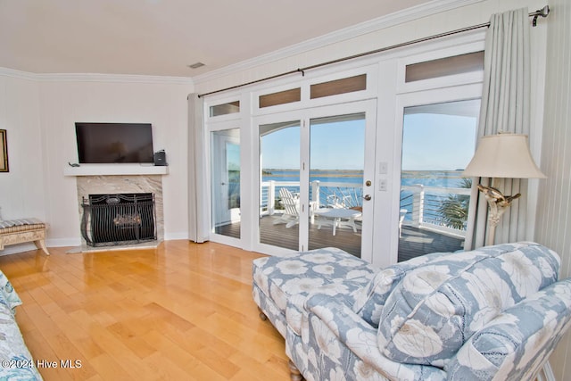 living room with a fireplace, hardwood / wood-style floors, and ornamental molding